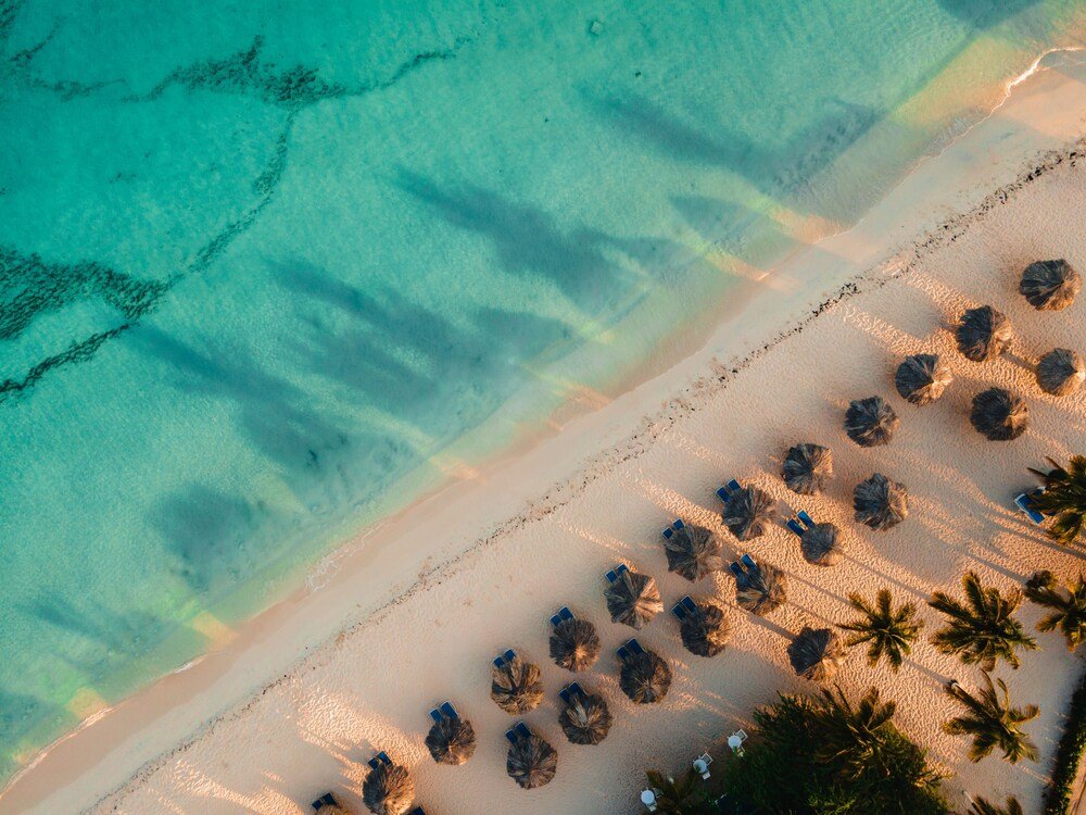 Aerial view of a beach with clear turquoise water
