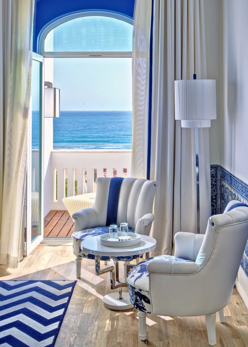Balcony with an ocean view and a white armchair