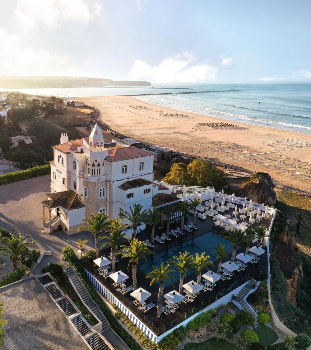 Coastal hotel with a large pool area and a beach view