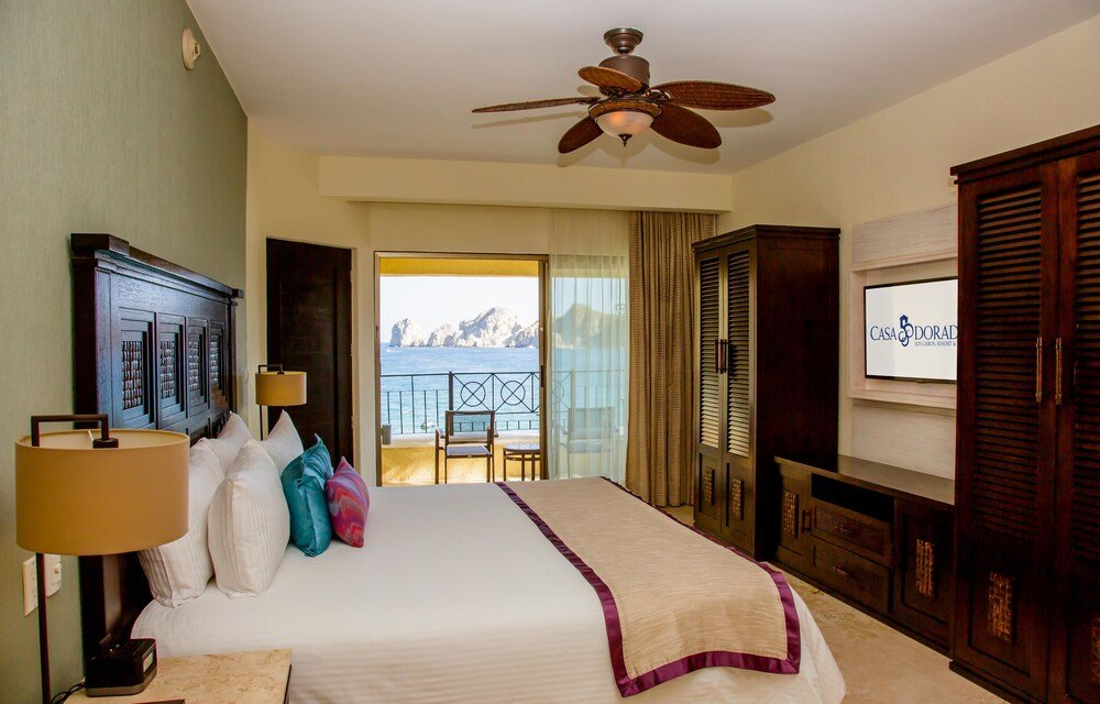 Hotel room with a bed and a ceiling fan at Casa Dorada Los Cabos