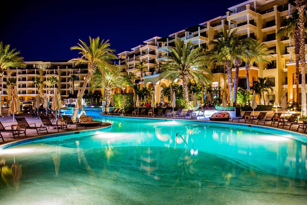 Hotel pool area with several lounge chairs at Casa Dorada Los Cabos