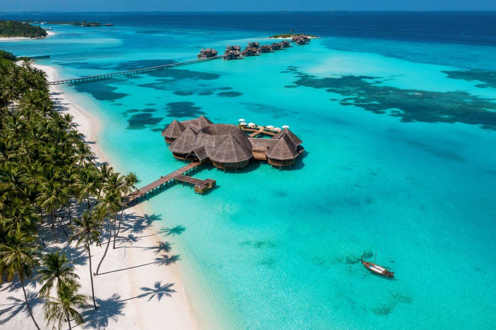 Overwater bungalow resort with thatched roofs over the lagoon