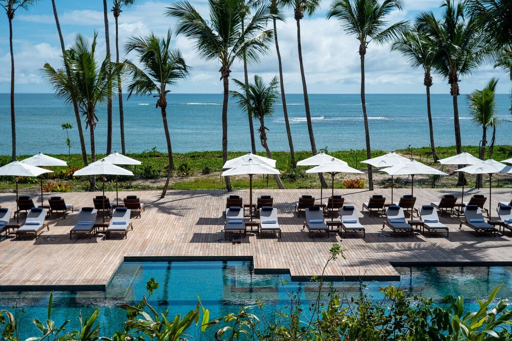 Poolside area with lounge chairs and umbrellas