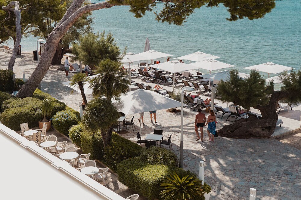 Beachside patio with outdoor seating and umbrellas