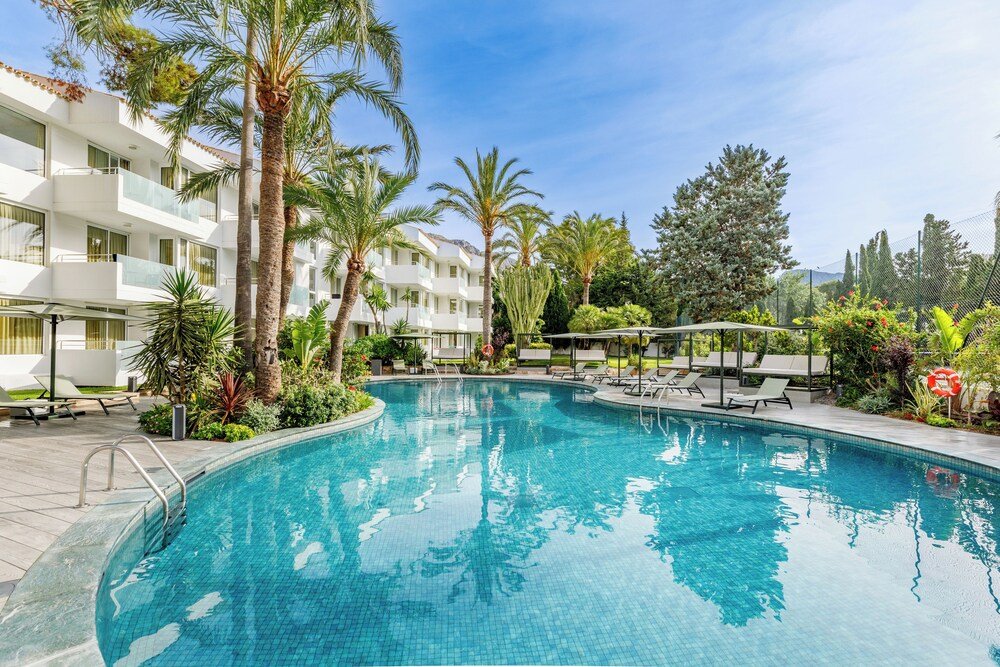 Swimming pool with lounge chairs and palm trees