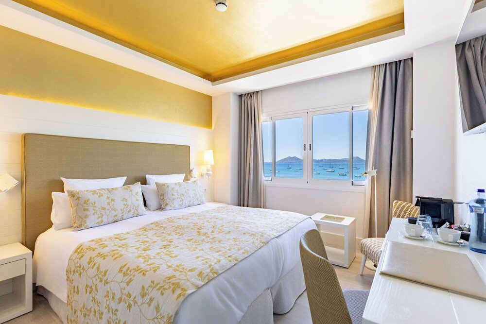 Hotel room with a large bed and a desk