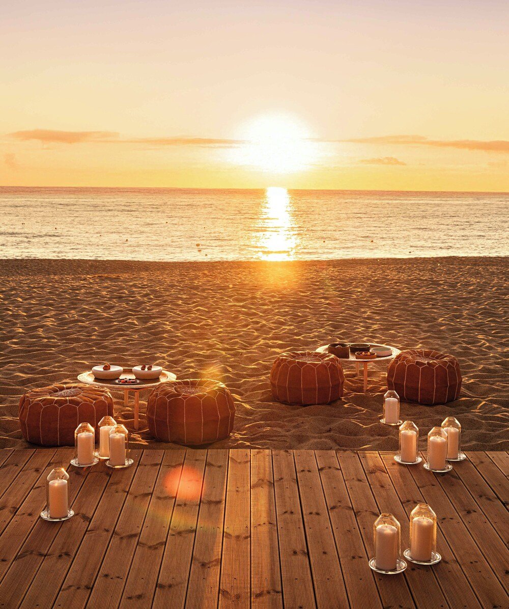Wooden deck with round cushions and candle holders