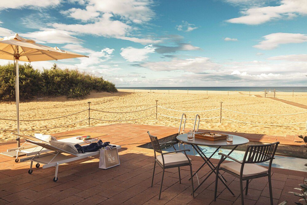 Beachside lounge with a pool and lounge chairs