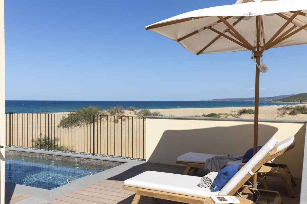 Balcony with a pool and lounge chairs