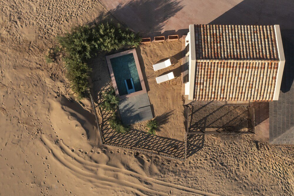 Aerial view of the resort and pool among the dunes