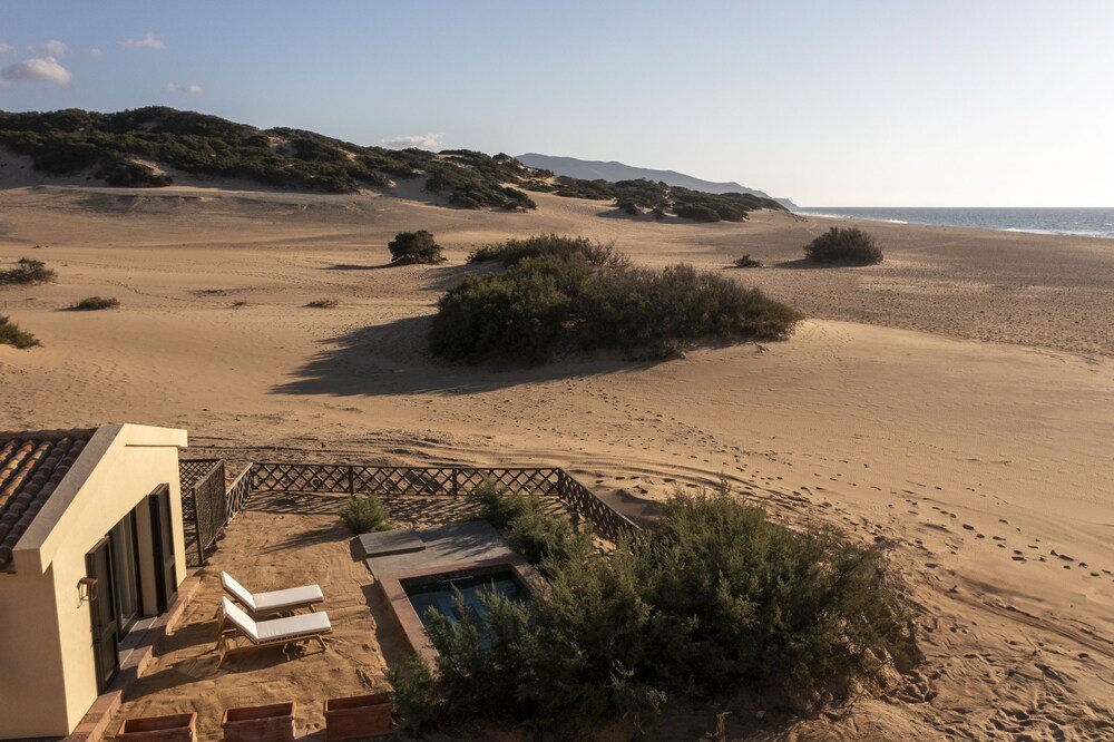 Aerial view of a coastal landscape with a sandy beach