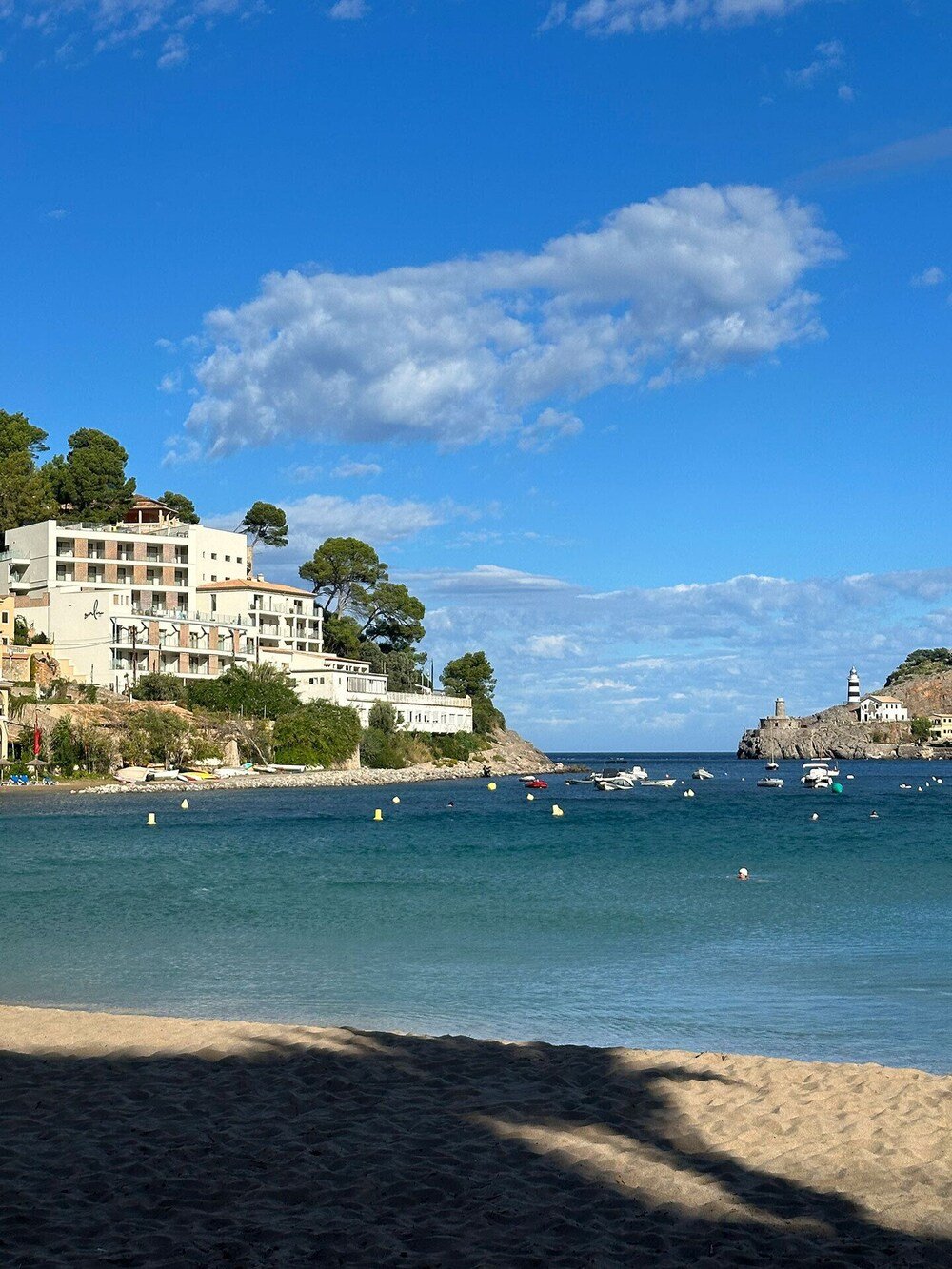 Coastal hotel with several floors beside a sandy beach