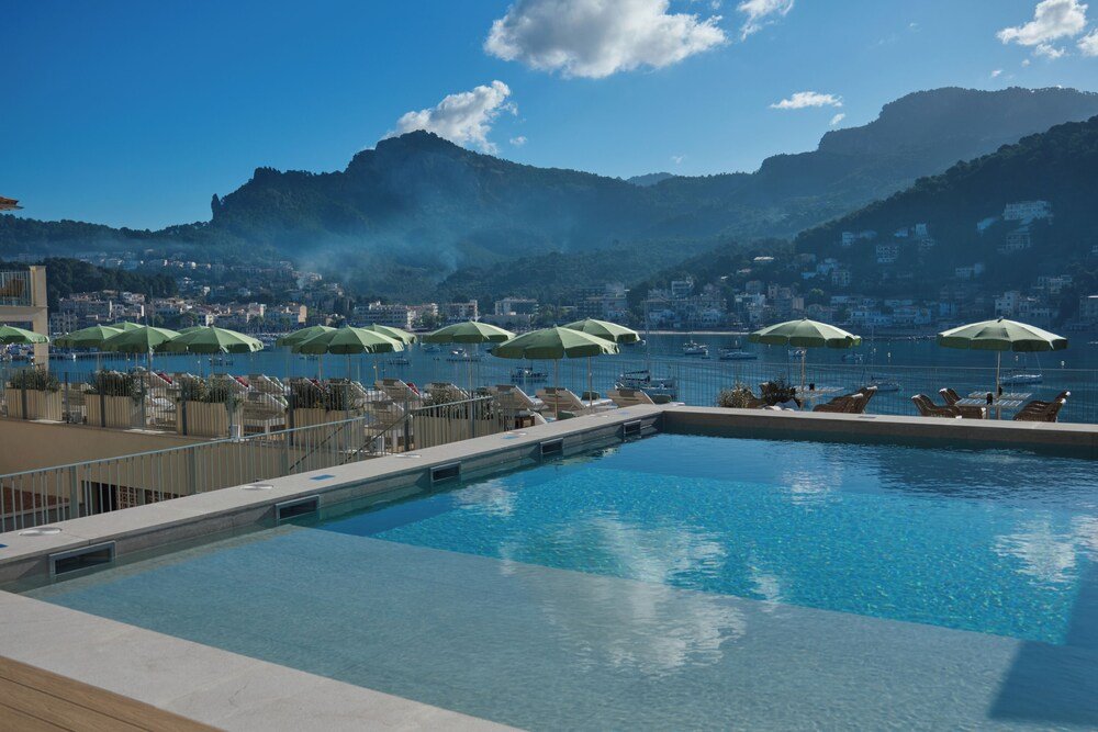 Pool area with green umbrellas and lounge chairs