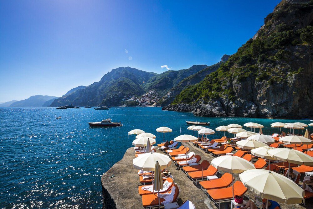Coastal area with a row of sun loungers and umbrellas