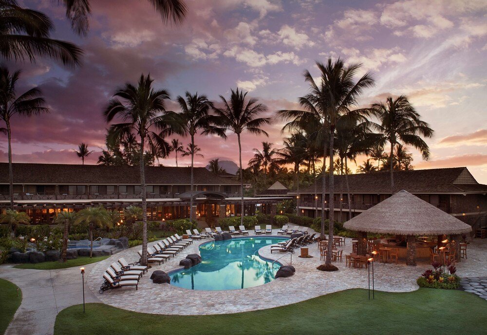 Resort pool area with lounge chairs and a bar