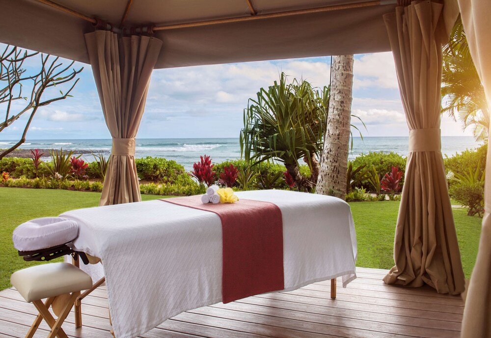 Massage table with a white sheet and a red towel