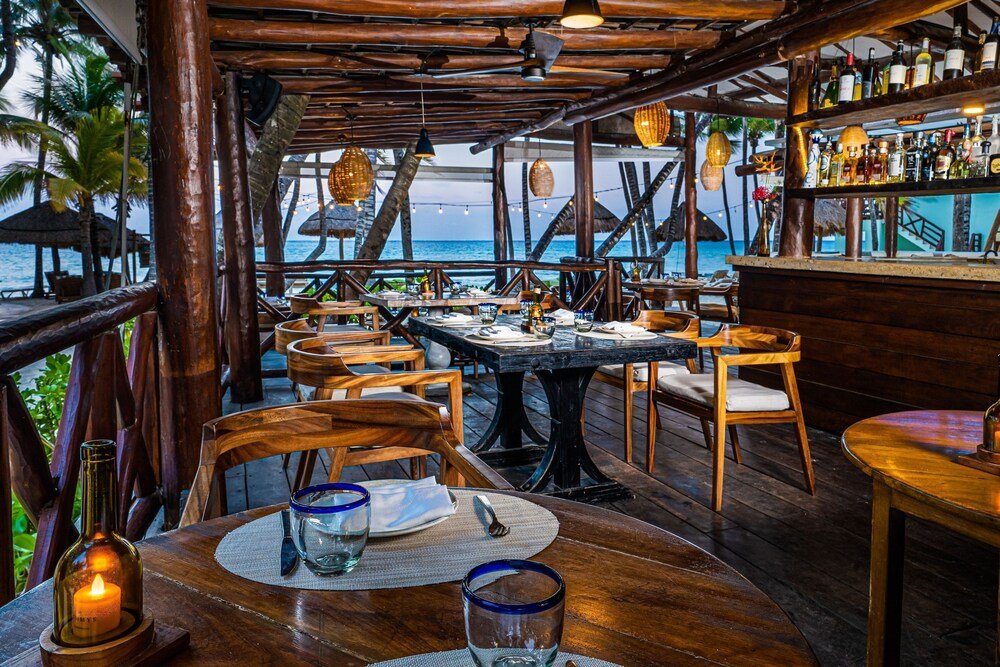 Outdoor restaurant with wooden tables and chairs at the resort