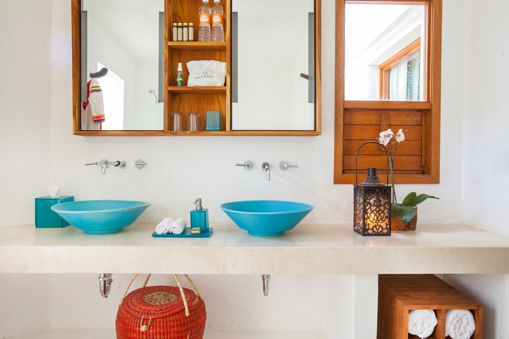 Guest bathroom with two blue sinks and a mirror