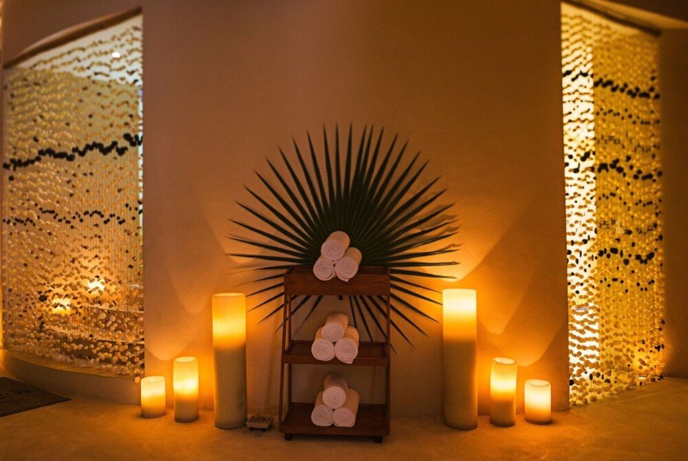 Spa area with rolled towels and candles at the resort