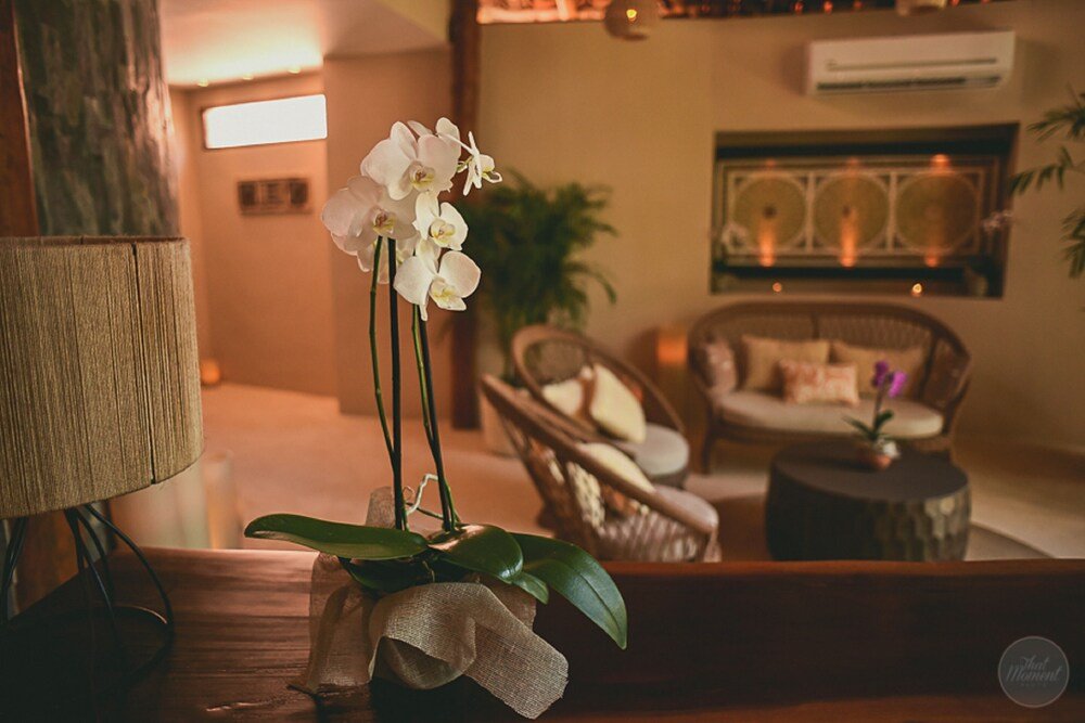 Beachside lounge with wicker furniture and thatched umbrellas