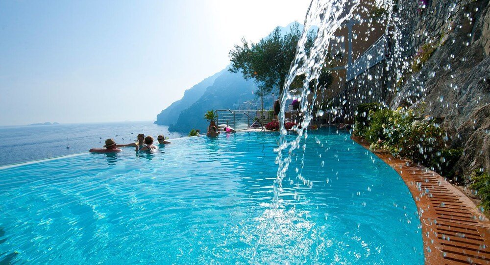 Pool with clear blue water and a waterfall feature