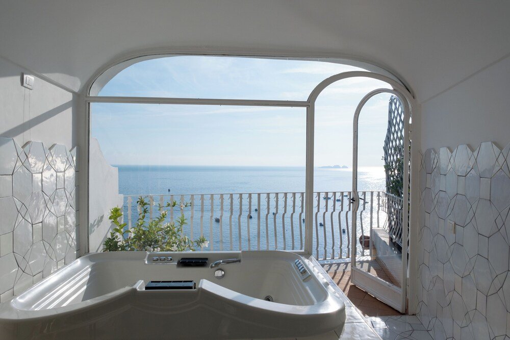 Bathroom with a large bathtub and a view of the sea