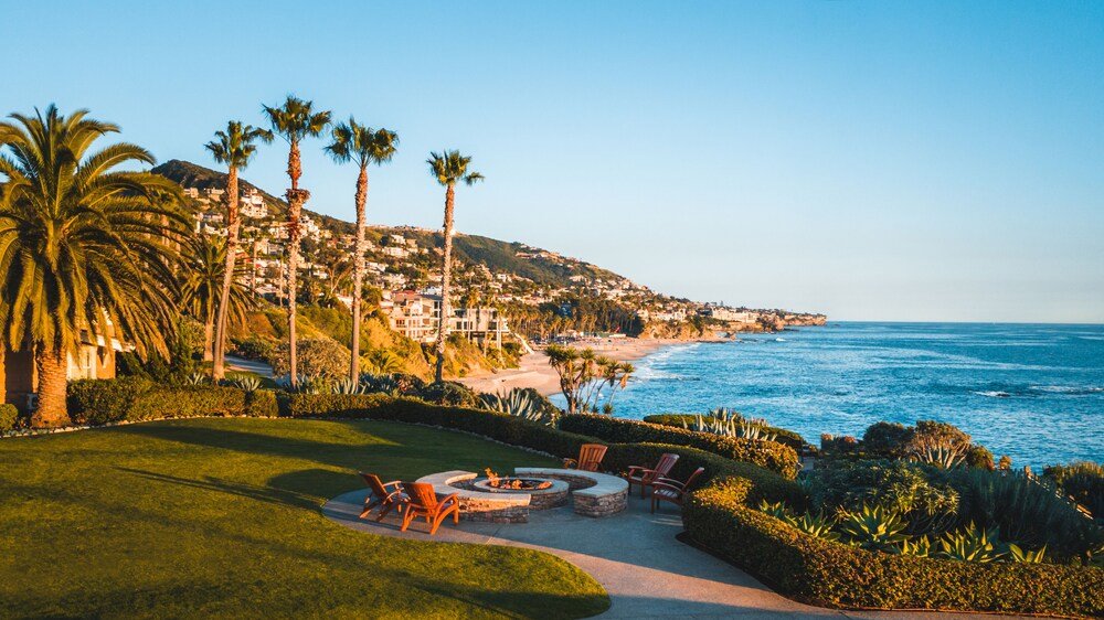 Coastal view with a well-maintained lawn above the water