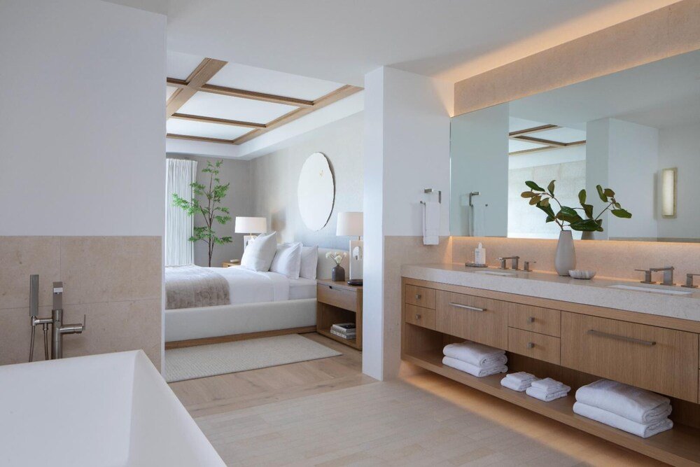 Modern hotel room with a large bed and seating