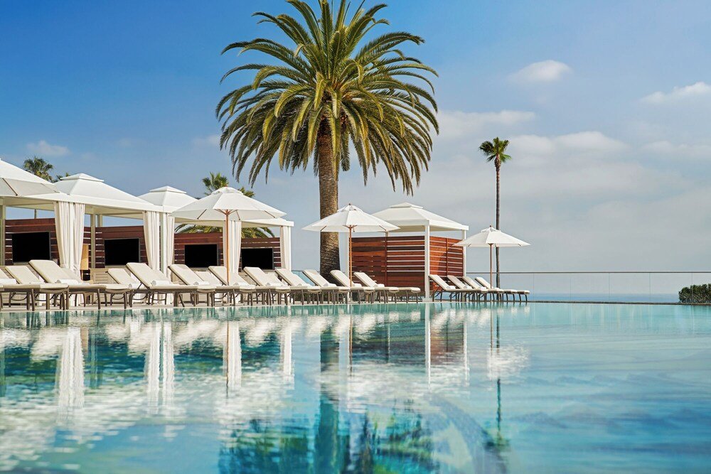 Poolside area with lounge chairs and umbrellas at the resort