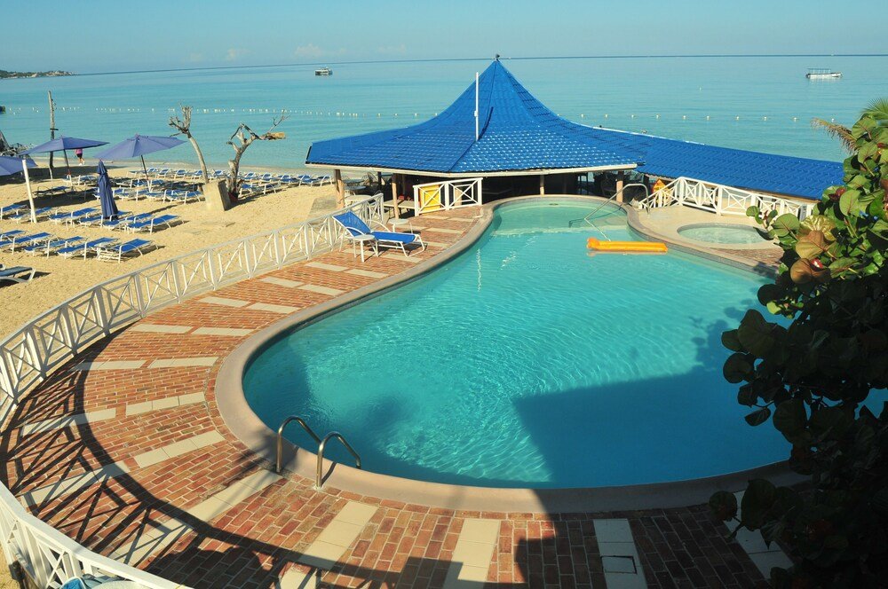 Pool area with a blue roof and lounge chairs