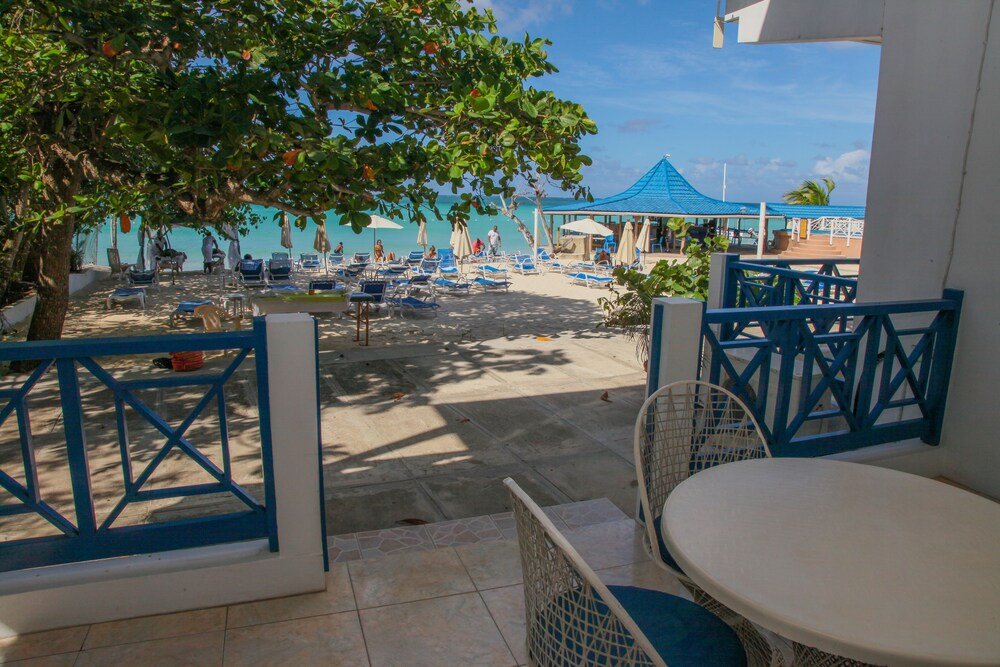 Beachside patio with blue and white furniture
