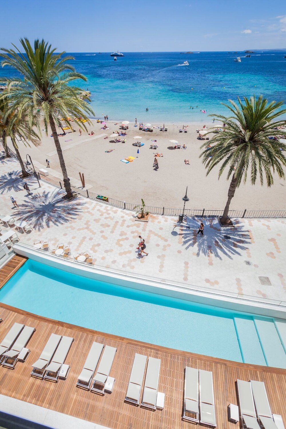 Poolside view with the beach and sea in the background