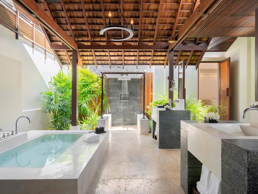 Spa area with a large bathtub and two sinks
