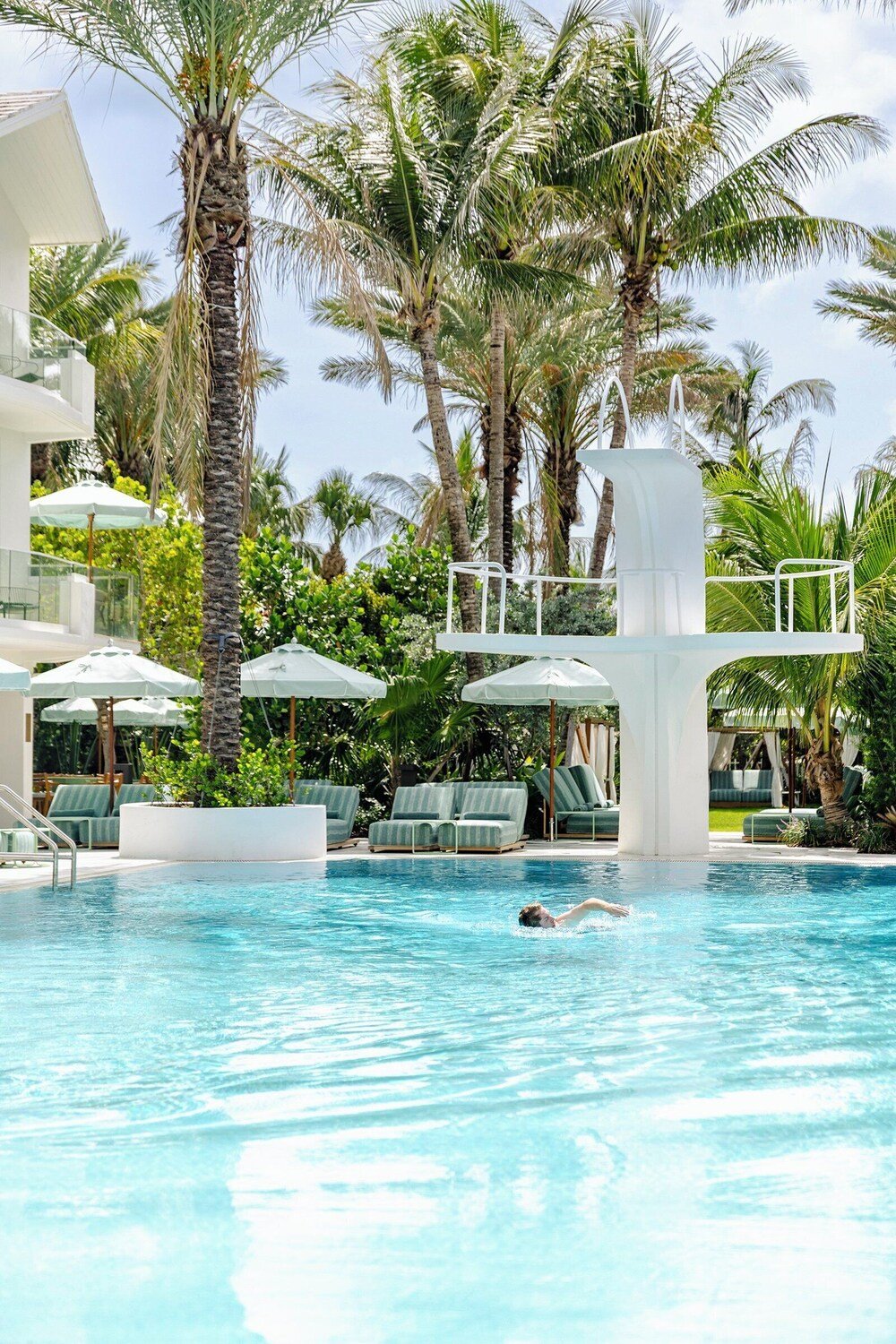 Swimming pool with lounge chairs and umbrellas