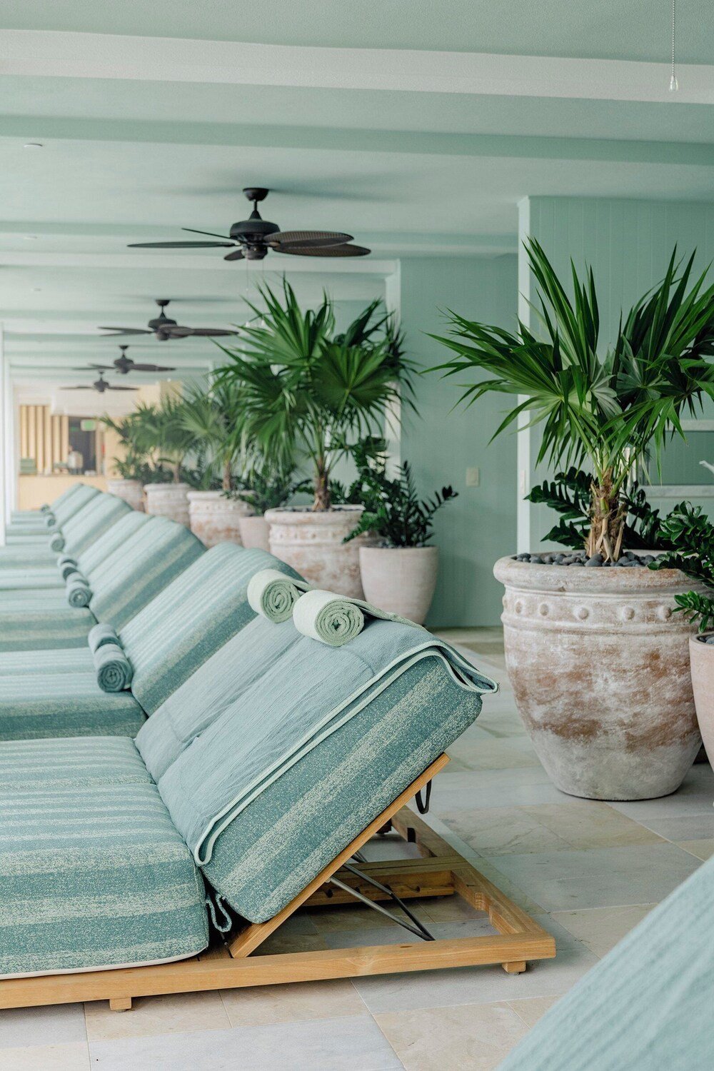 Beach with green umbrellas and lounge chairs